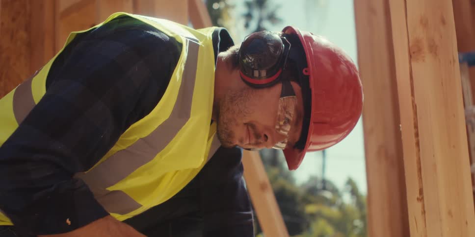 A construction worker uses a dewalt circular saw to cut a piece of wood