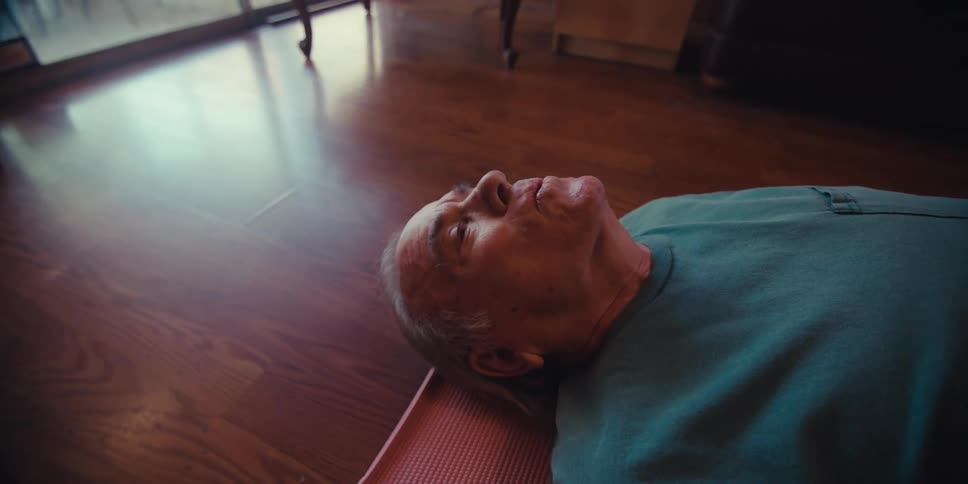 A man doing yoga takes a deep breath