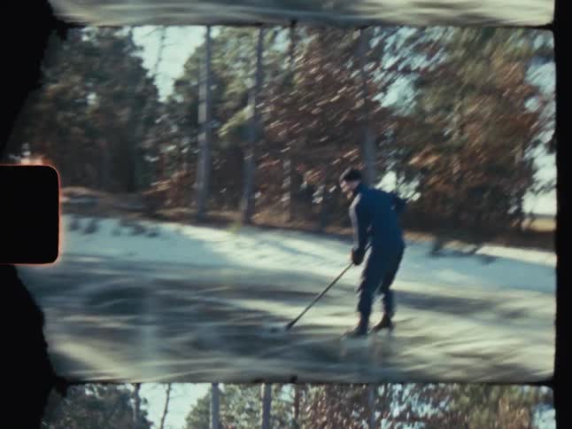 A person playing hockey on a frozen lake under the sun surrounded by a serene winter forest