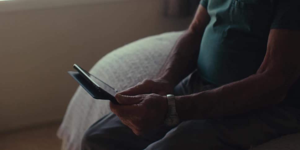 A man slides on his tablet