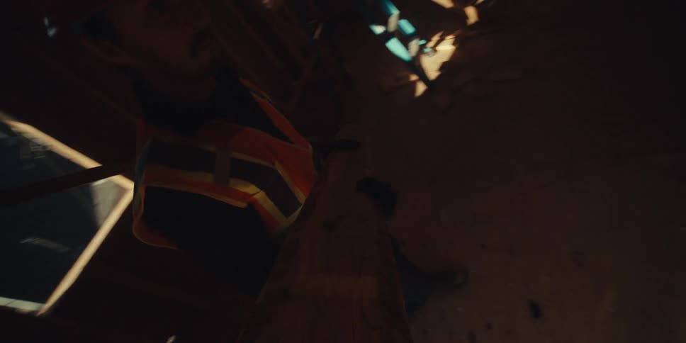 A man is carrying a plank of wood in the home