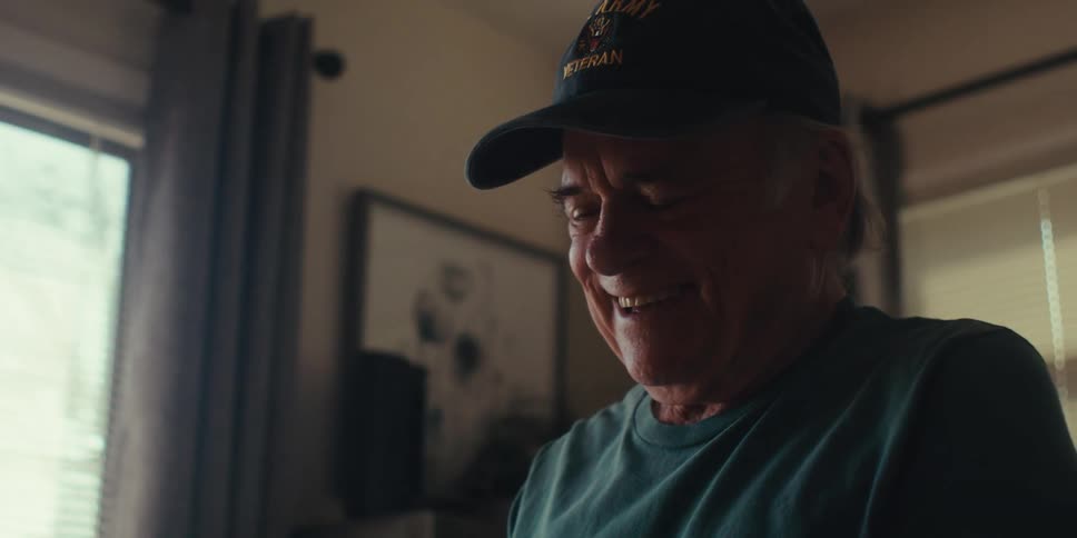 Happy elderly man interacting with a tablet