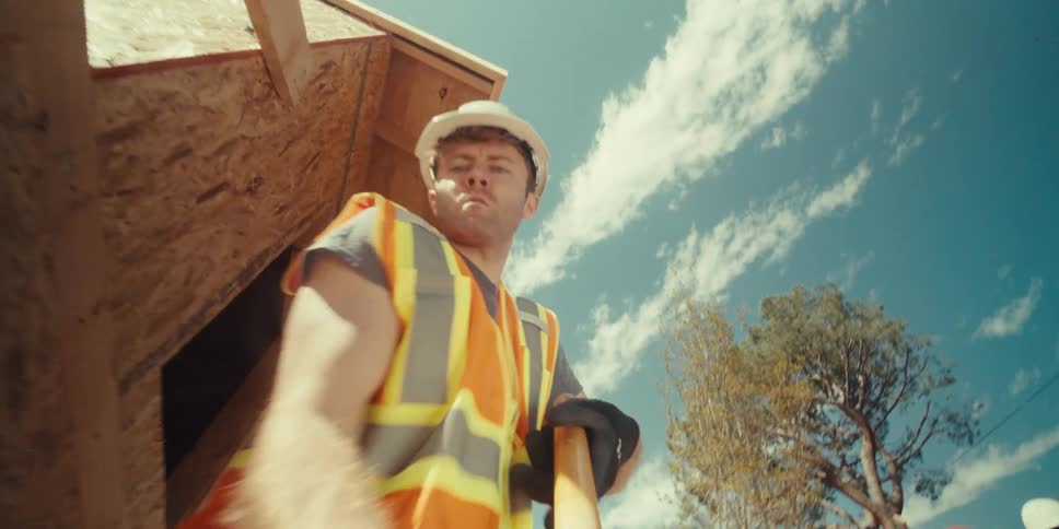A construction worker is digging then takes a rest
