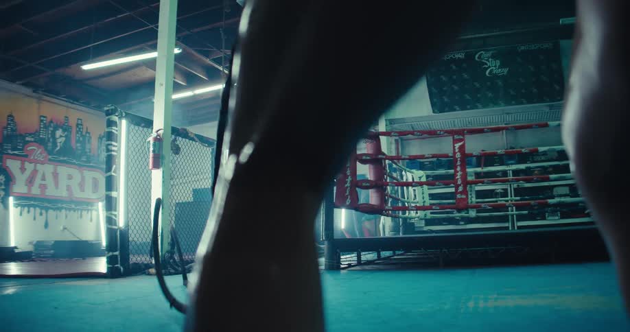 Trained woman working out in the gym with heavy ropes