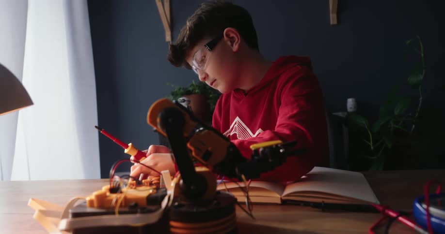 A child is working on robotics on his desk