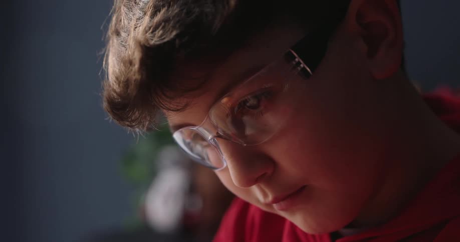 Boy wears safety glasses while working on a project at home