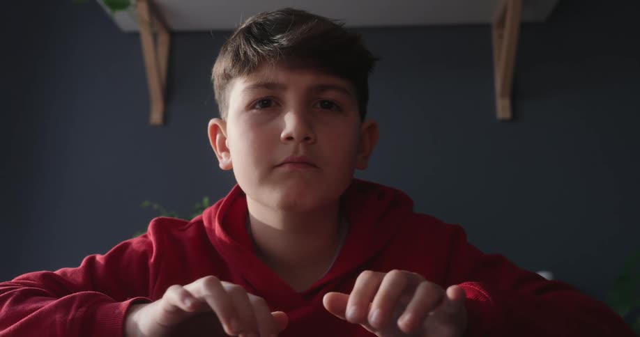 A child is typing and nodding