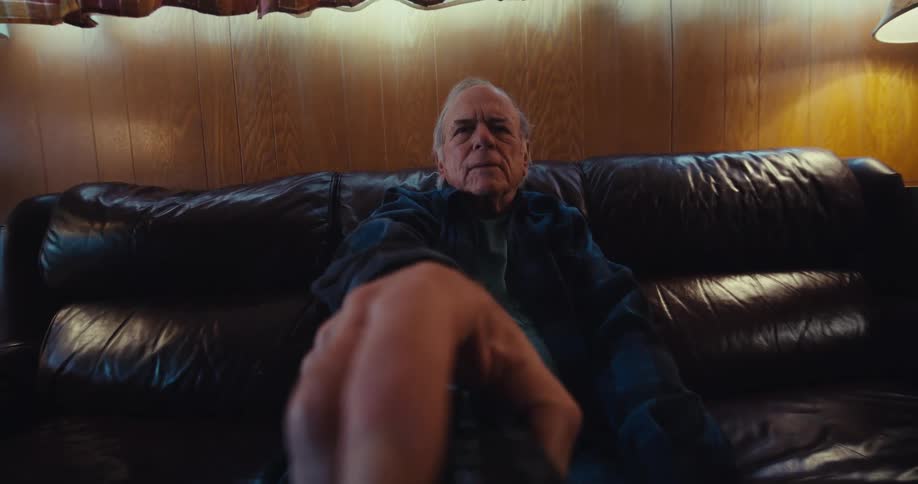 A man laughs while using the remote