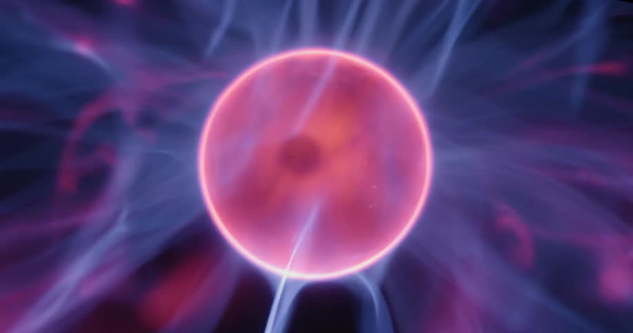 In a speededup sequence the camera zooms closer to the plasma globes center orb revealing vibrant waves of energy radiating outward in flickering arcs as pinkish and purplish lines dance across the dark background