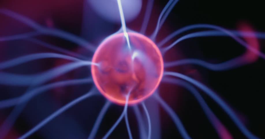 From a static vantage the plasma globes center orb releases vibrant beams of energy in multiple directions each flickering arc dancing across the dark background in mesmerizing neon hues
