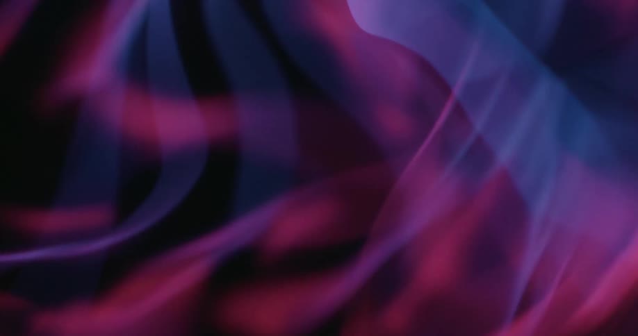 A pink glowing ball with several blue segments moving on a black background