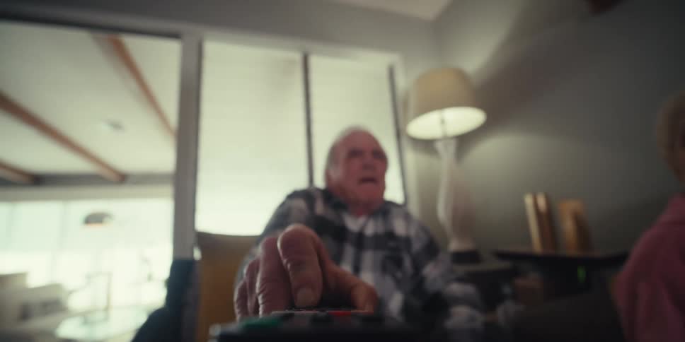 A man picks up the television remote