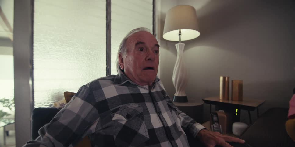 Sitting elderly man who assumes a surprised expression