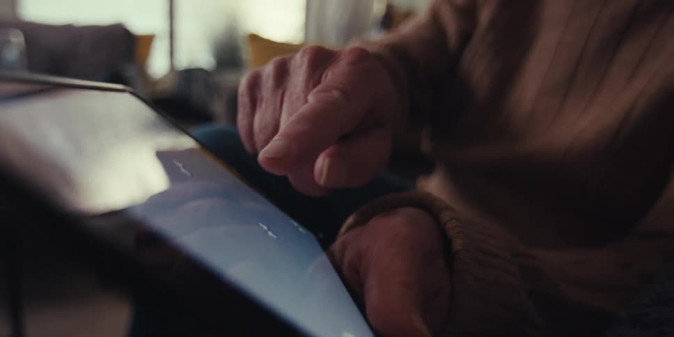 A man slides his finger on the tablet