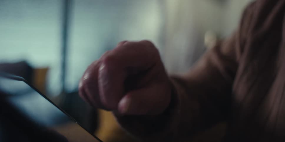 A footage of an elderly man operating a tablet