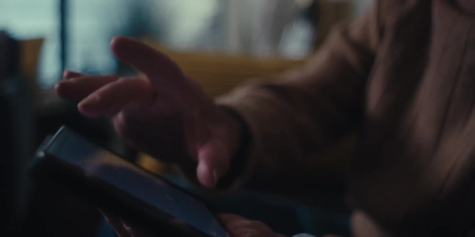 A man is confusing while using a tablet