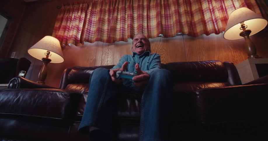 A footage of an elderly man playing a game on a console
