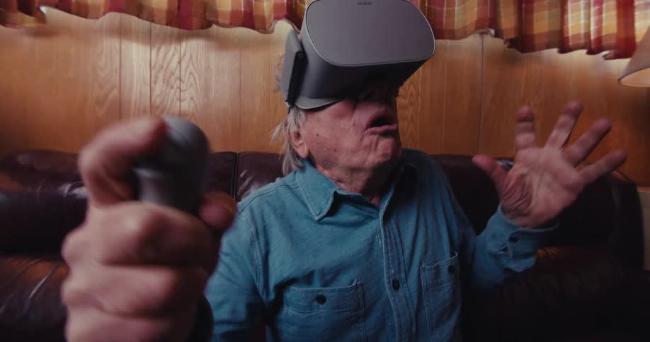 Elderly man playing with a visor and becoming enthusiastic