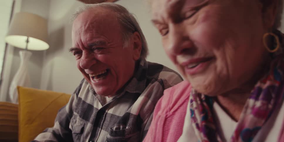 A footage of elderly male and female making a call