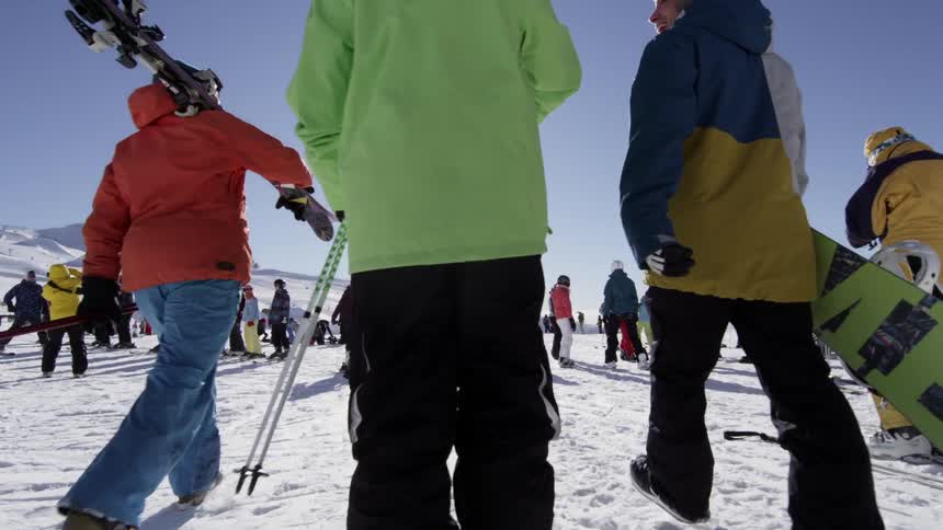 A bunch of people out skiing and snowboarding