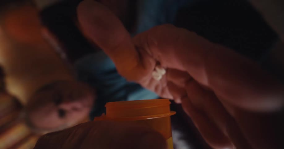 A man takes medication with water