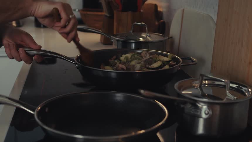 A man is cooking in a pan