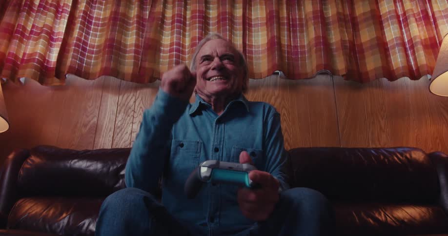 While playing video games the man cheers