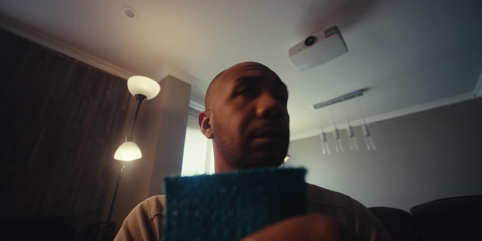A man examines a fabric square