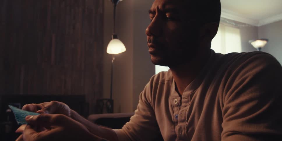 Thoughtful man holding an object with his hands