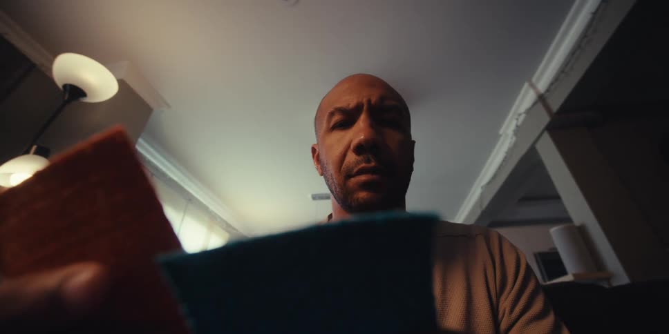 A man examines two squares of material