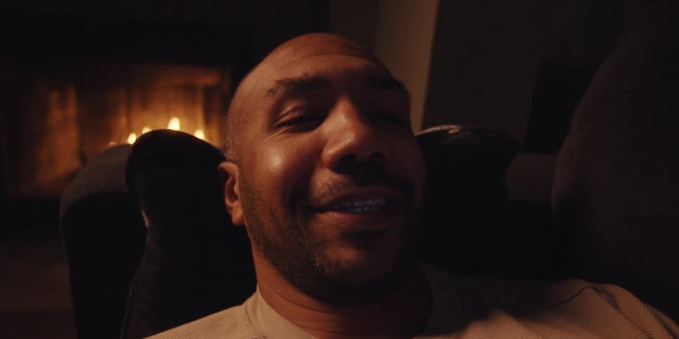 Cheerful man lying on the sofa in the living room