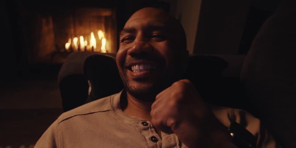 A man cheers at his cell phone
