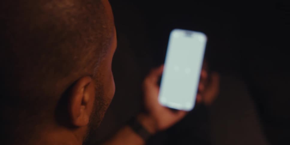 Man smiles and nods while making a video call on his smartphone