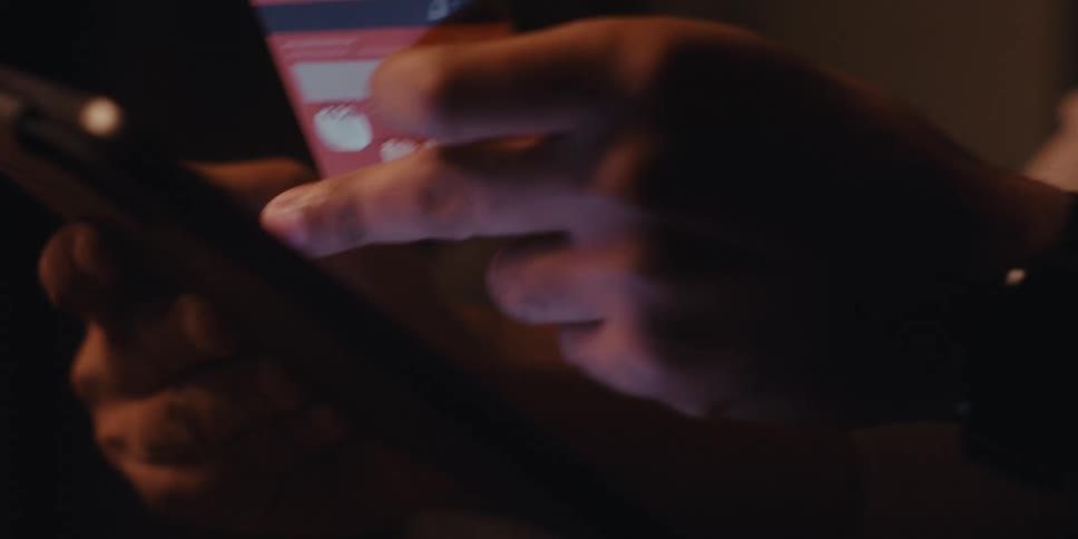 Hands entering a credit card code into a tablet