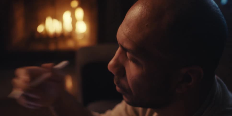 A man holds a pen and thinks something over