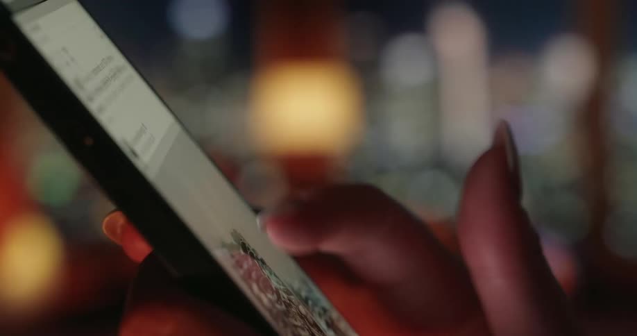 A woman scrolling the feed on her cell phone