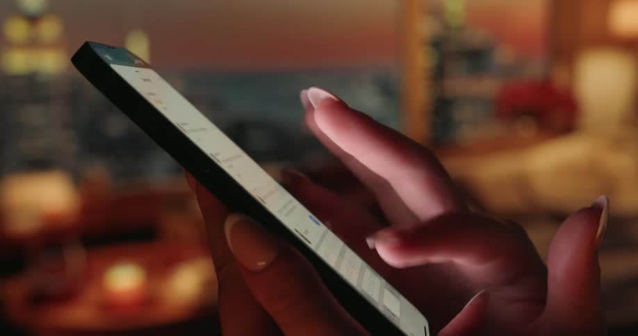 A woman types something out on her cell phone