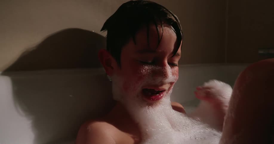 Child bathing and playing with foam