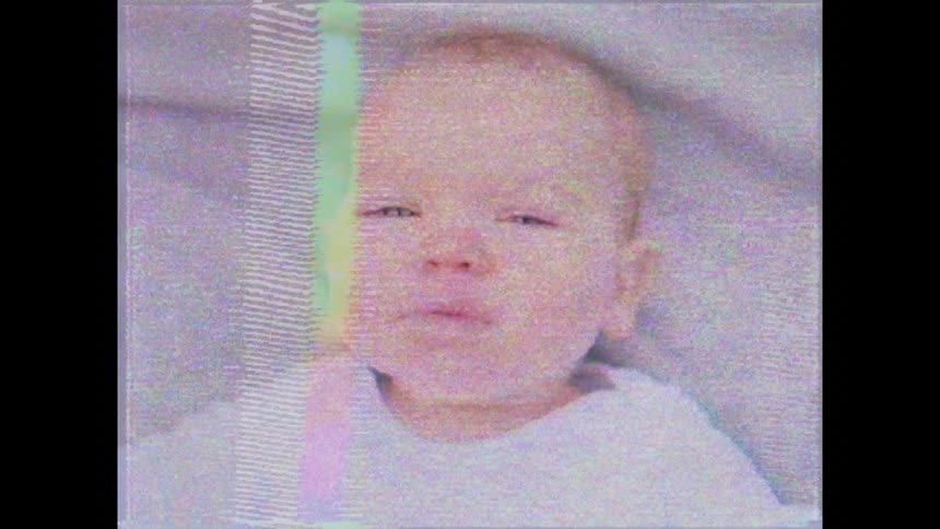 A baby smiles and moves
