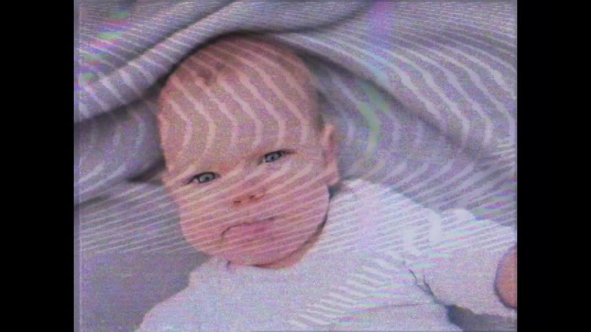 A baby is swinging his arms