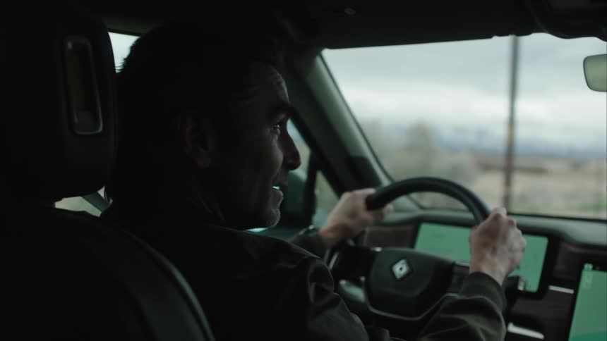A man is driving and talking
