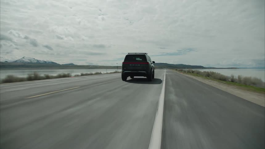A sports utility vehicle drives on the long road