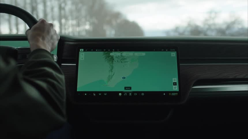 A man is driving using a map on the display on the dashboard