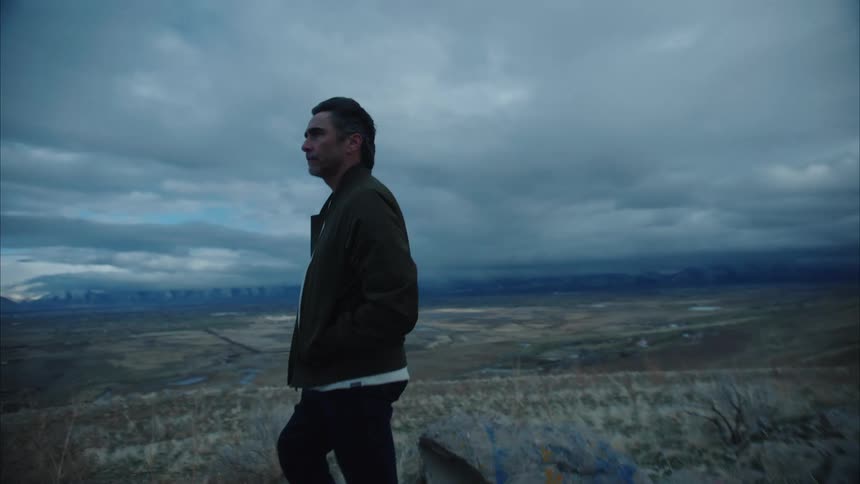 A man walks on the hill to look out over the landscape