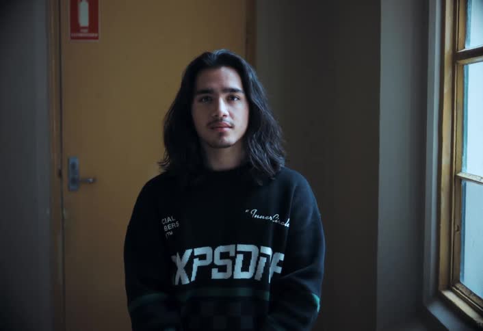 Boy with long hair looking at the camera
