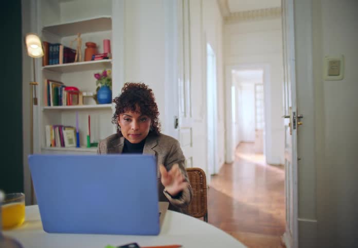 A footage of a lady making a video call on a laptop