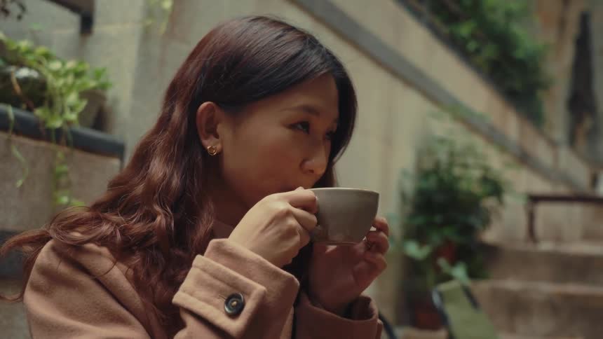 A footage of a happy lady drinking from a cup