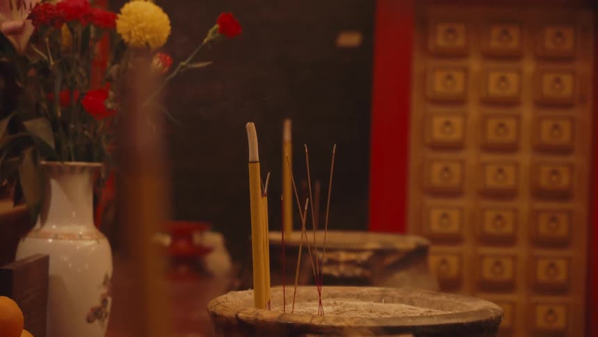 Smoke flows from some incense sticks