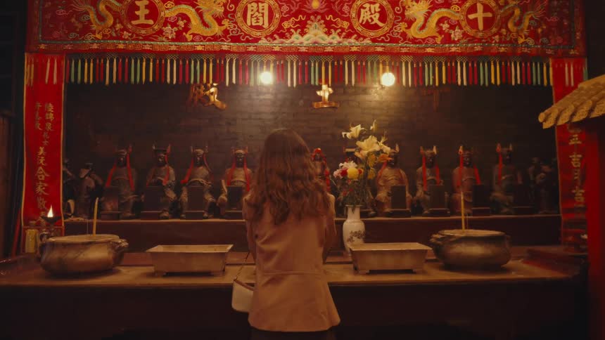 A woman is praying at the altar