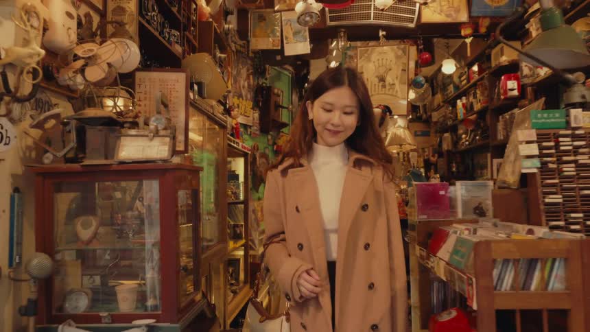 A woman smiles as she walks out of a store